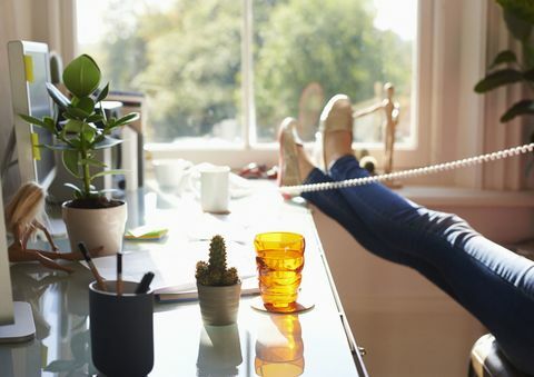 Жена, говореща по телефона в домашния офис - само показани краката и краката